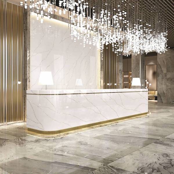 Venato Sparkle by Hanex Solid Surfaces on reception desk in hotel lobby